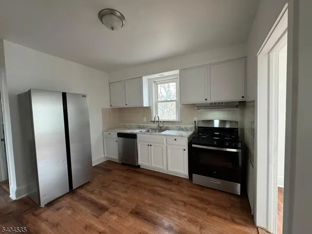 a kitchen with a refrigerator stove and a sink