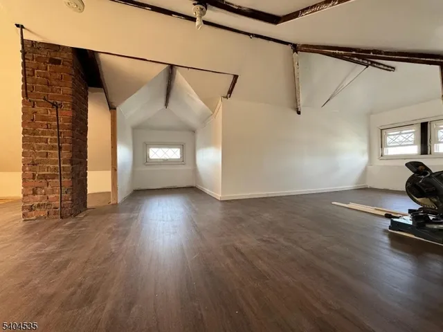 a view of a room with wooden floor and windows