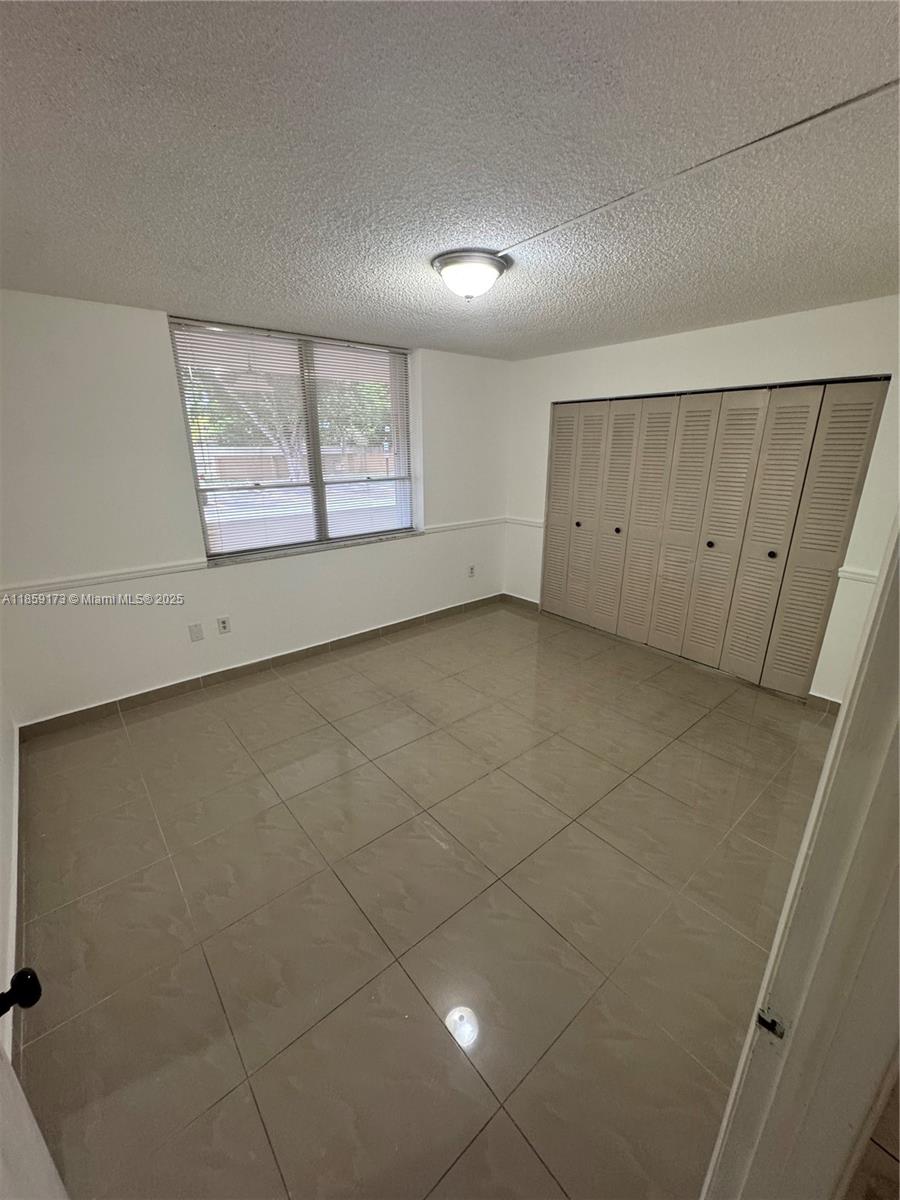 6841 Southwest 147th Avenue, Unit 1H Miami, FL 33193 - Photo 13 of 26 a view of an empty room with a window