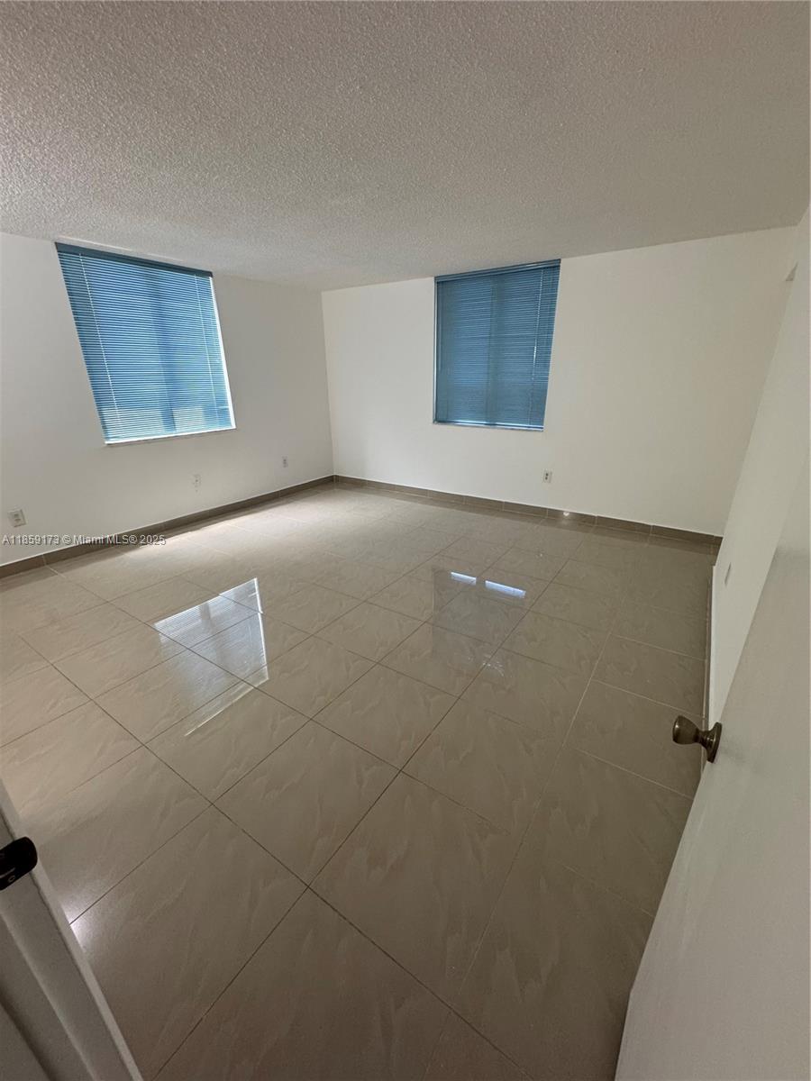 6841 Southwest 147th Avenue, Unit 1H Miami, FL 33193 - Photo 14 of 26 a view of an empty room with a window