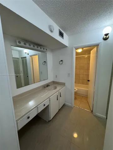 a bathroom with a toilet a sink and bathtub