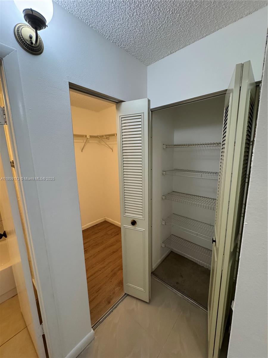 6841 Southwest 147th Avenue, Unit 1H Miami, FL 33193 - Photo 18 of 26 a view of walk in closet