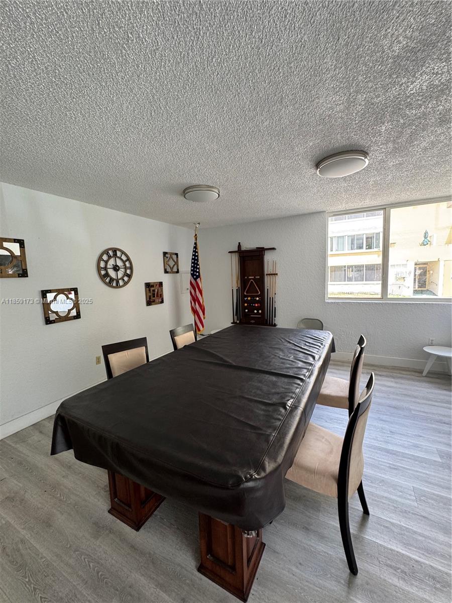 6841 Southwest 147th Avenue, Unit 1H Miami, FL 33193 - Photo 23 of 26 a living room with a table chairs and a window