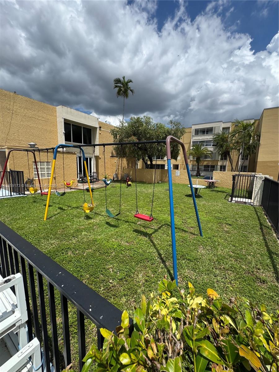6841 Southwest 147th Avenue, Unit 1H Miami, FL 33193 - Photo 25 of 26 a view of a garden with a slide