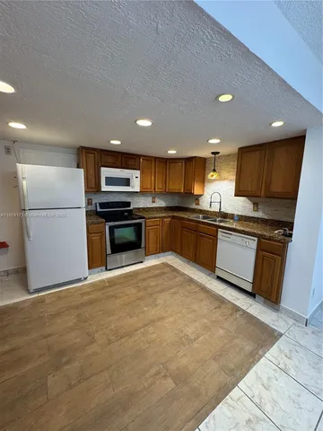 a view of hallway with an empty space and a window
