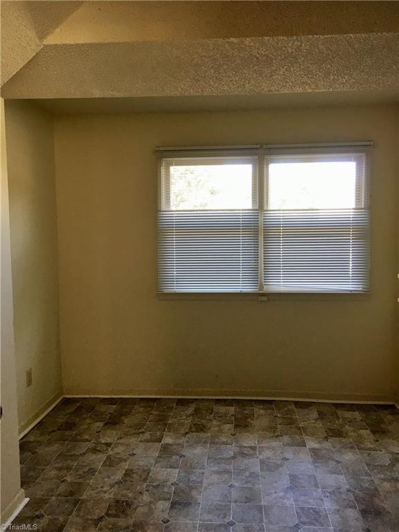 5905 High View Road Greensboro, NC 27410 - Photo 12 of 22 A real laundry room with shelving and access to the heat/air/water heater.
