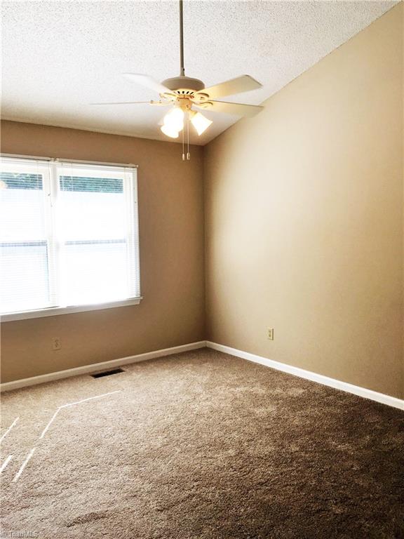5905 High View Road Greensboro, NC 27410 - Photo 15 of 22 Master bedroom also has vaulted ceilings, natural light, walk in closet, and oversized private bath.