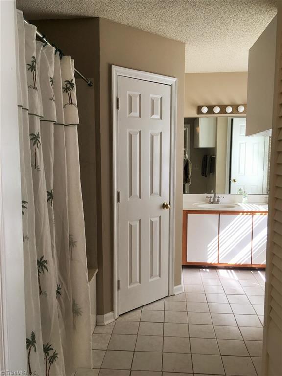 5905 High View Road Greensboro, NC 27410 - Photo 17 of 22 Master bath is clean and spacious. Walk in closet, tile floor, double sinks.