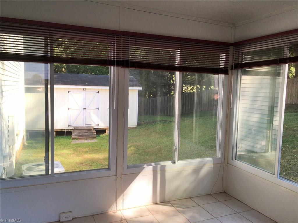 5905 High View Road Greensboro, NC 27410 - Photo 19 of 22 Sunroom has easy to clean tile floor and sliding windows to let in the fresh air on those cool fall nights!