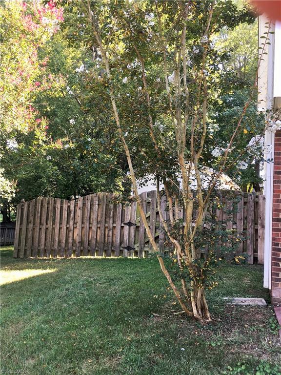 5905 High View Road Greensboro, NC 27410 - Photo 21 of 22 Side yard. Lots of pretty blooming trees.
