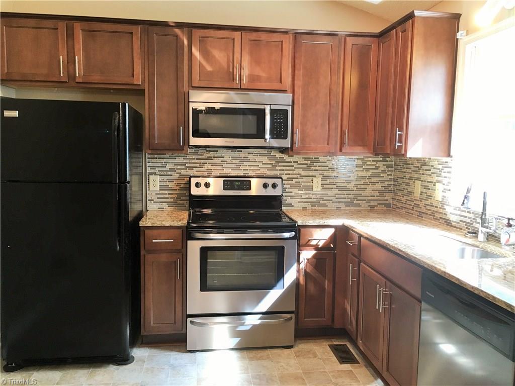 5905 High View Road Greensboro, NC 27410 - Photo 4 of 22 Fantastic new kitchen! Beautiful granite, new stainless appliances, and modern cabinetry.