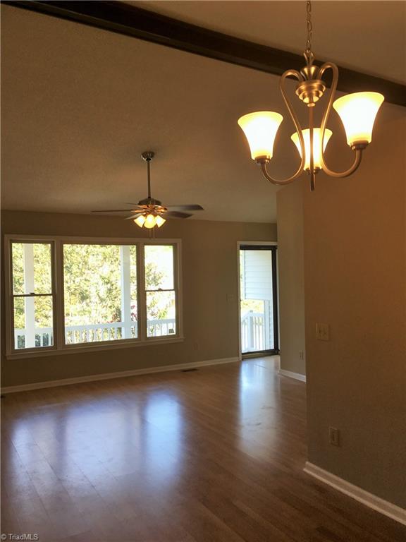5905 High View Road Greensboro, NC 27410 - Photo 7 of 22 Vaulted ceilings, beam, pretty lights, and open to dining.
