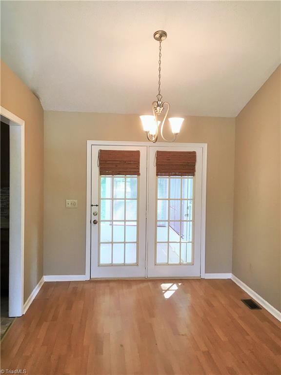 5905 High View Road Greensboro, NC 27410 - Photo 9 of 22 French doors lead to the sunroom and then to a beautifully fenced yard.