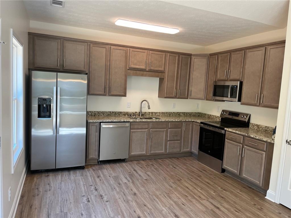 202 Gamel Road Dallas, GA 30157 - Photo 9 of 34 a kitchen with granite countertop a refrigerator stove top oven and sink