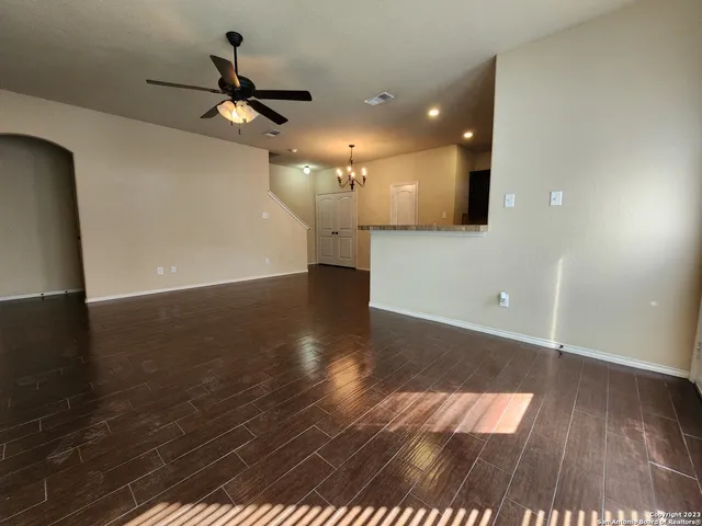 a view of a livingroom with a ceiling fan and wooden floor
