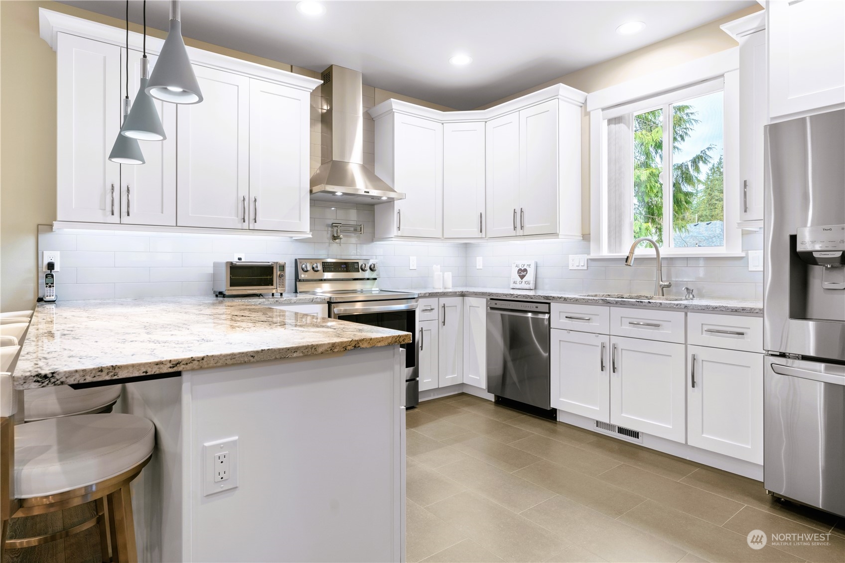 8487 Cimarron Way Maple Falls, WA 98266 - Photo 18 of 39 a kitchen with stainless steel appliances granite countertop a sink window and cabinets