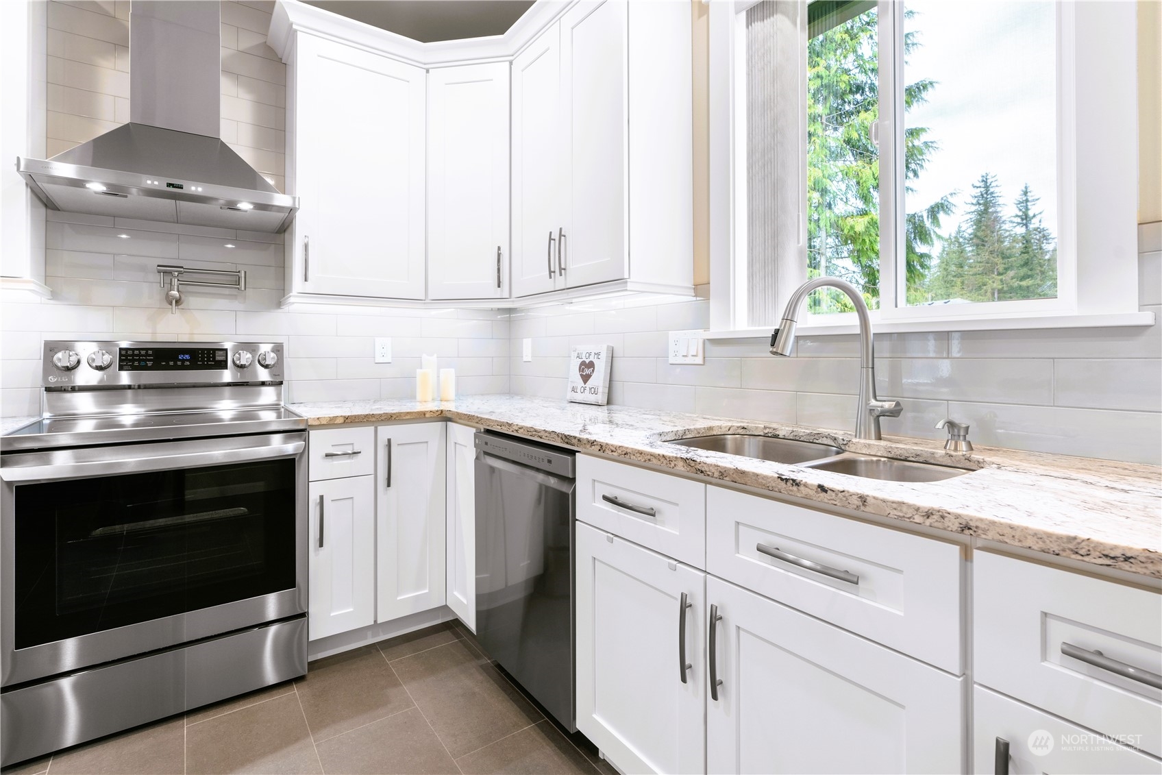 8487 Cimarron Way Maple Falls, WA 98266 - Photo 23 of 39 a kitchen with granite countertop white cabinets stainless steel appliances and sink