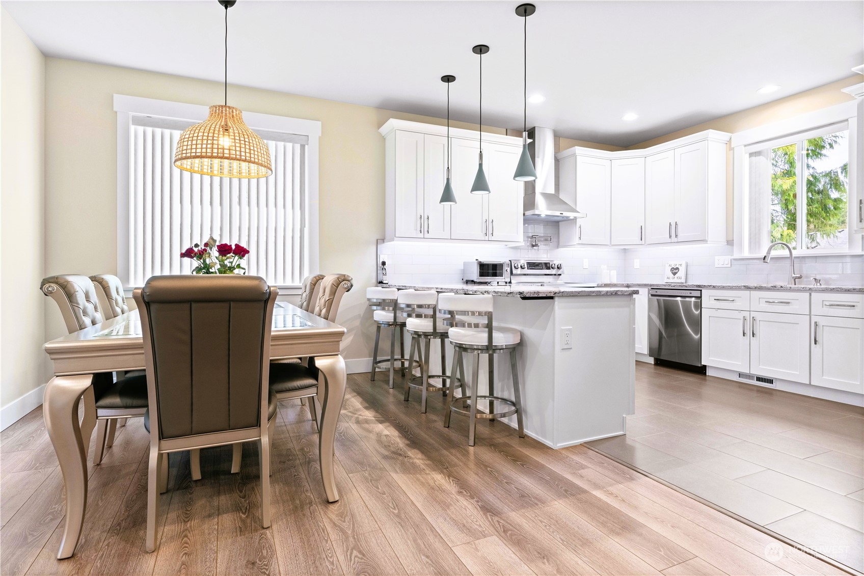 8487 Cimarron Way Maple Falls, WA 98266 - Photo 24 of 39 a kitchen that has a lot of cabinets in it with a dining table and chairs