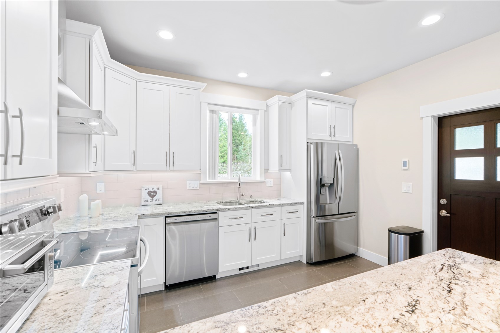 8487 Cimarron Way Maple Falls, WA 98266 - Photo 25 of 39 a kitchen with stainless steel appliances granite countertop a refrigerator sink and cabinets