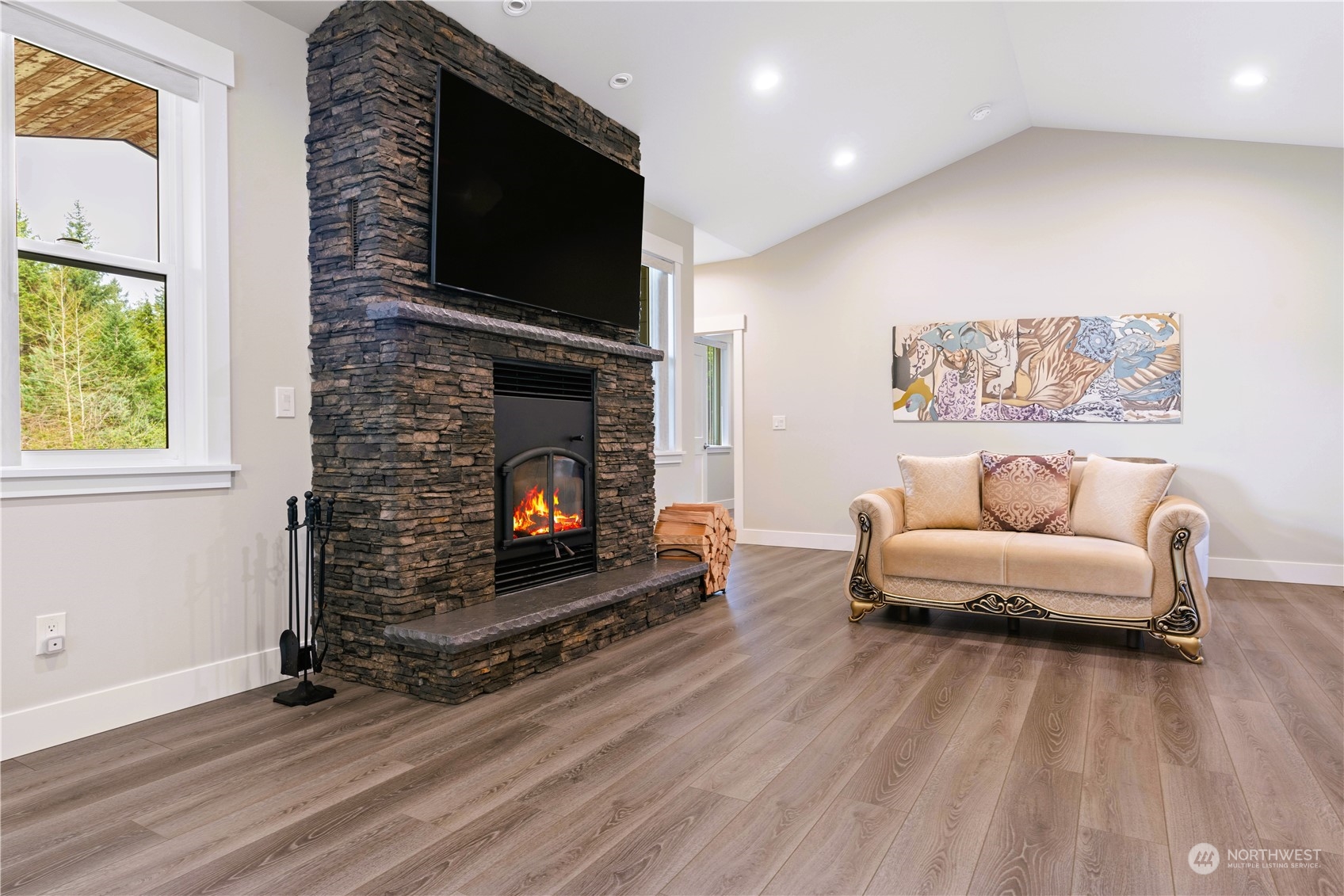 8487 Cimarron Way Maple Falls, WA 98266 - Photo 28 of 39 a living room with furniture a flat screen tv and a fireplace