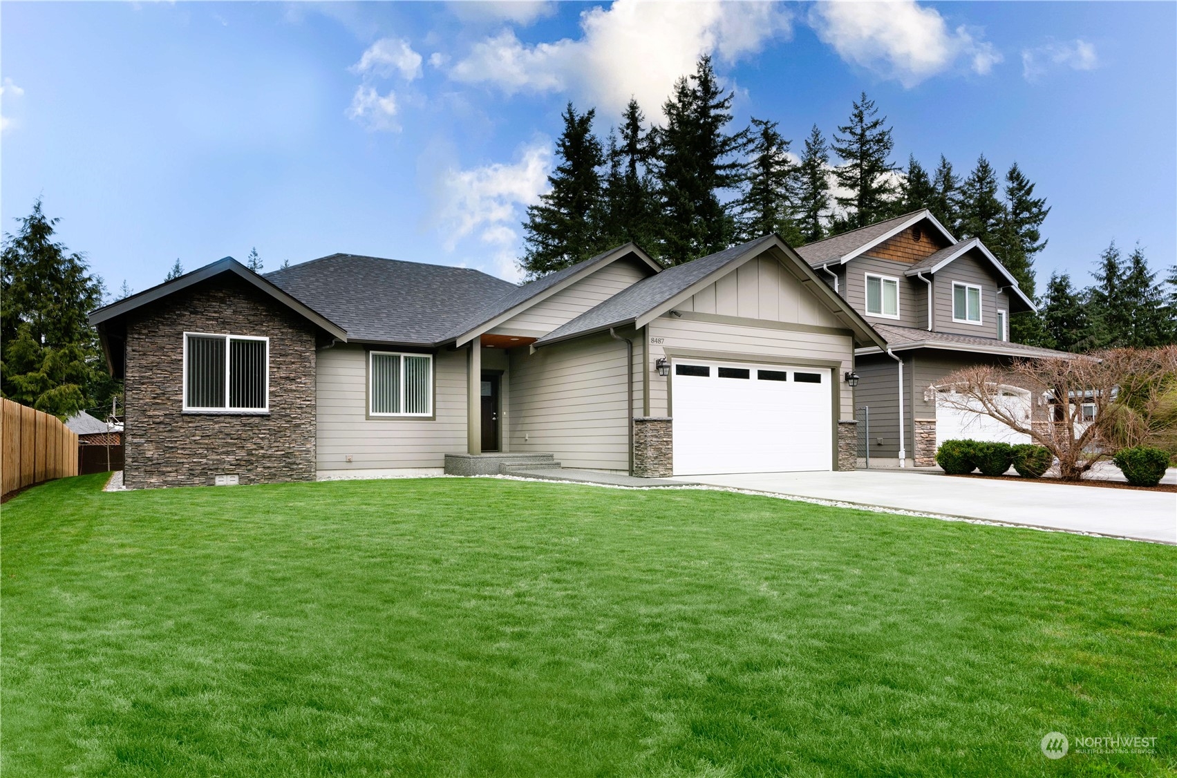 8487 Cimarron Way Maple Falls, WA 98266 - Photo 8 of 39 a front view of a house with a garden and yard