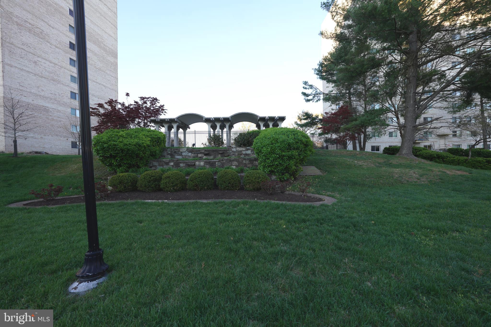 1111 University Boulevard West, Unit 1001A Silver Spring, MD 20902 - Photo 2 of 27 a view of a garden with a fountain