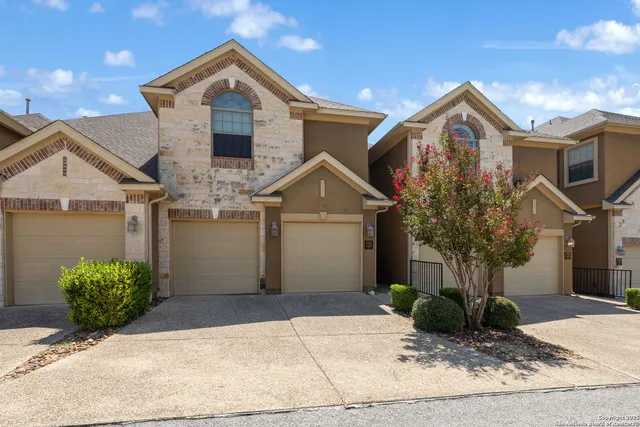 a view of a house with a yard and plants