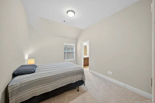 a bedroom with a bed and a lamp