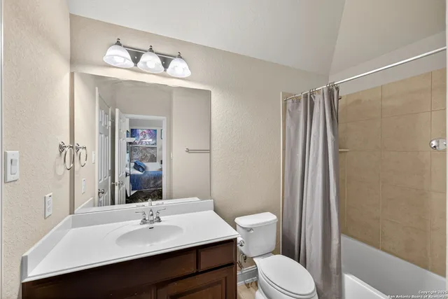 a bathroom with a sink vanity mirror and toilet