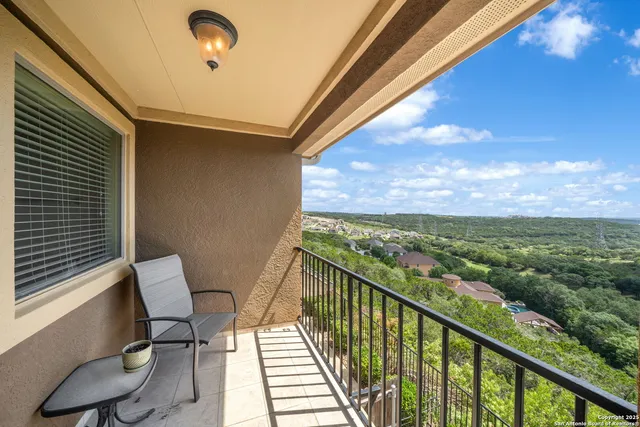 a view of a chair and table in the balcony