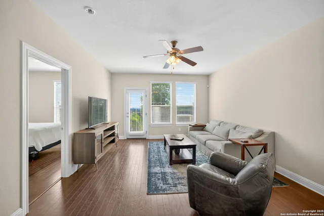 a living room with furniture fireplace and a flat screen tv