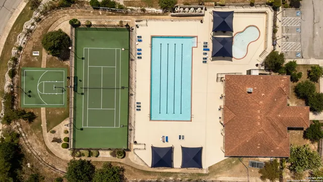 a view of a house with swimming pool and sitting area