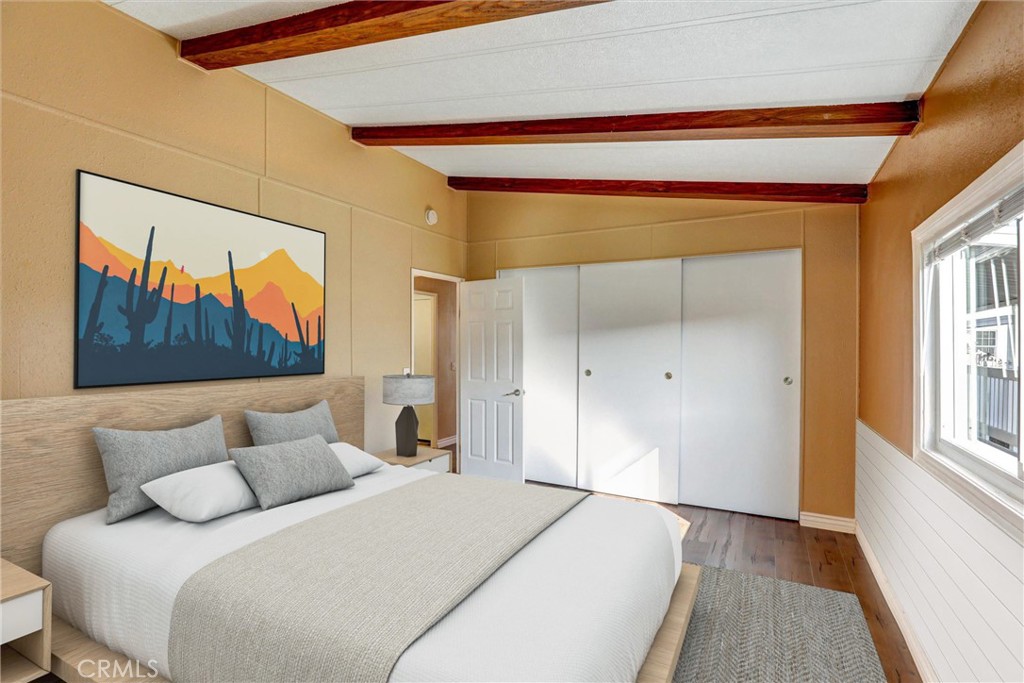 7700 Lampson Avenue, Unit 71 Garden Grove, CA 92841 - Photo 11 of 24 a bedroom with a bed and a painting on the wall