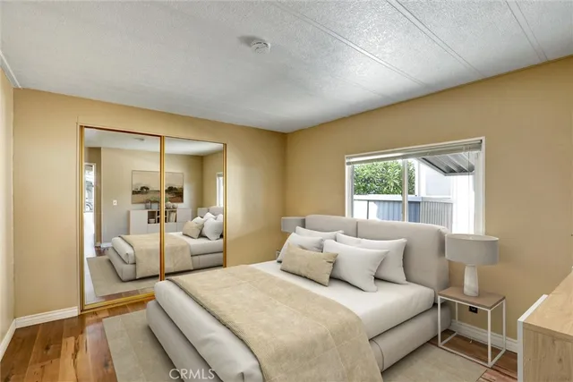 a bedroom with a bed and a large window