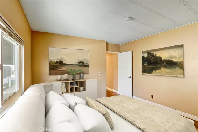 a bedroom with a bed and a painting on the wall