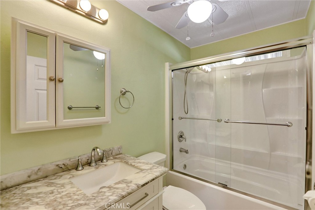 7700 Lampson Avenue, Unit 71 Garden Grove, CA 92841 - Photo 16 of 24 a bathroom with a granite countertop sink toilet and shower