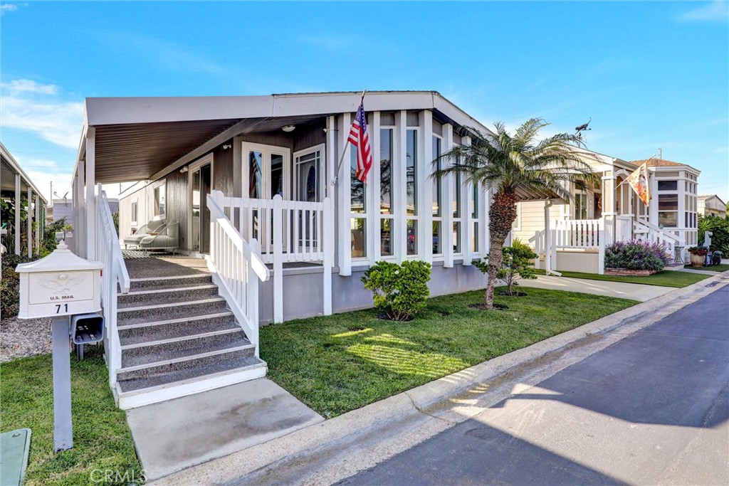 7700 Lampson Avenue, Unit 71 Garden Grove, CA 92841 - Photo 2 of 24 a front view of a house with a yard