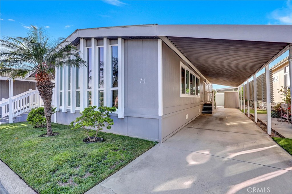 7700 Lampson Avenue, Unit 71 Garden Grove, CA 92841 - Photo 3 of 24 a view of a house with a yard