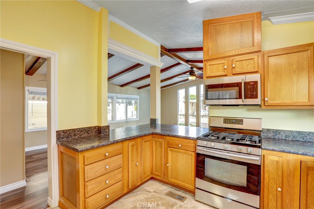 7700 Lampson Avenue, Unit 71 Garden Grove, CA 92841 - Photo 8 of 24 a kitchen with stainless steel appliances granite countertop a stove and a granite counter tops