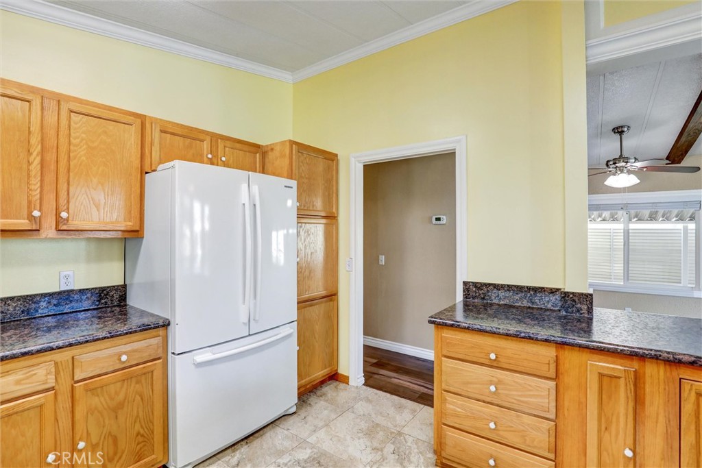 7700 Lampson Avenue, Unit 71 Garden Grove, CA 92841 - Photo 9 of 24 a white refrigerator freezer sitting in a kitchen