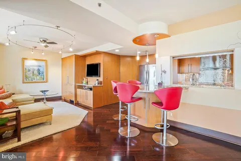 a living room with furniture and kitchen view
