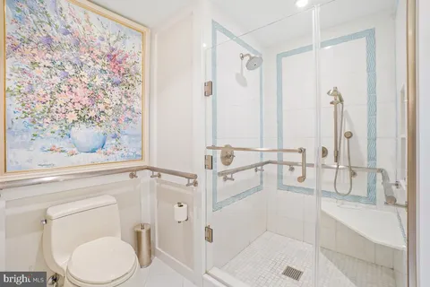 a bathroom with a toilet and a shower