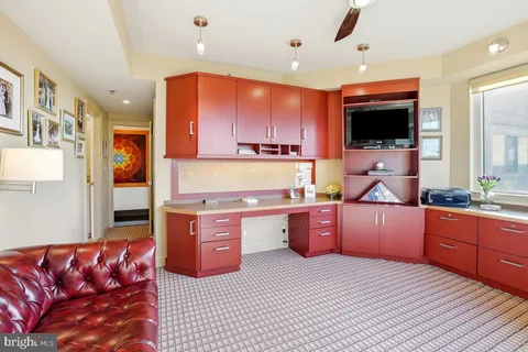 a large kitchen with stainless steel appliances kitchen island granite countertop a sink and cabinets