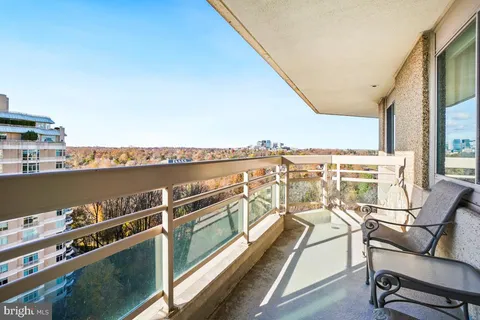 a view of a balcony with chairs