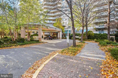 a front view of a building with trees