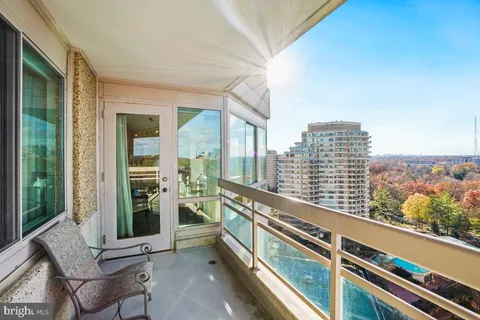 a view of balcony with furniture and city view