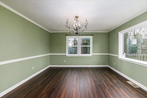 a view of room with window and hardwood floor