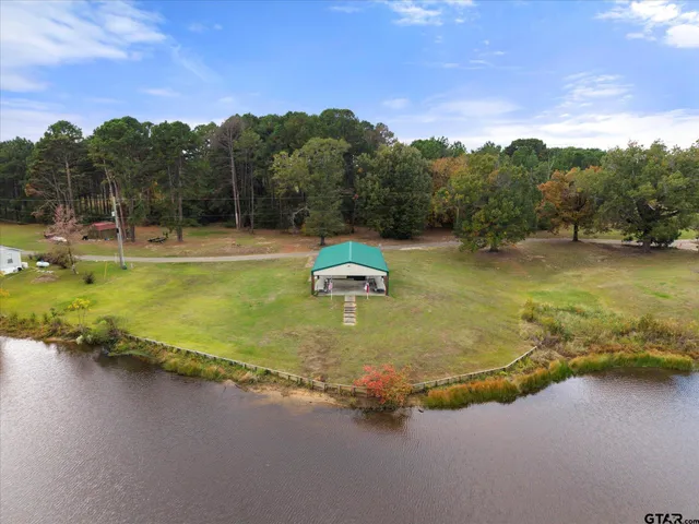 a swimming pool with trees in the background