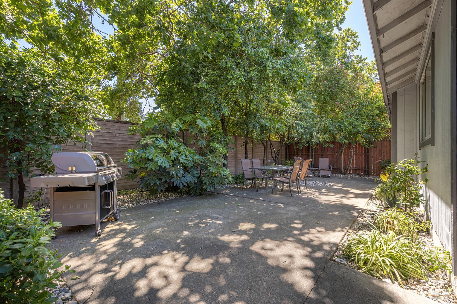 1935 Seville Street Santa Rosa, CA 95403 - Photo 20 of 30 a view of a backyard with table and chairs and a large tree