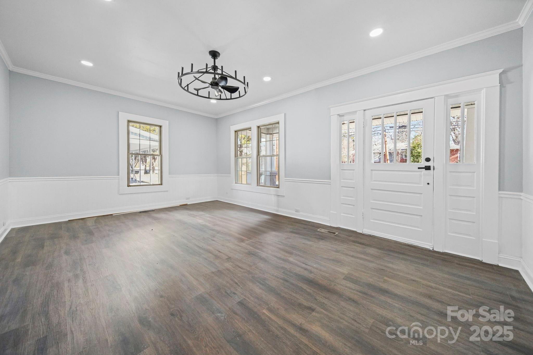 113 7th Street Spencer, NC 28159 - Photo 17 of 44 a view of an empty room with a window and wooden floor